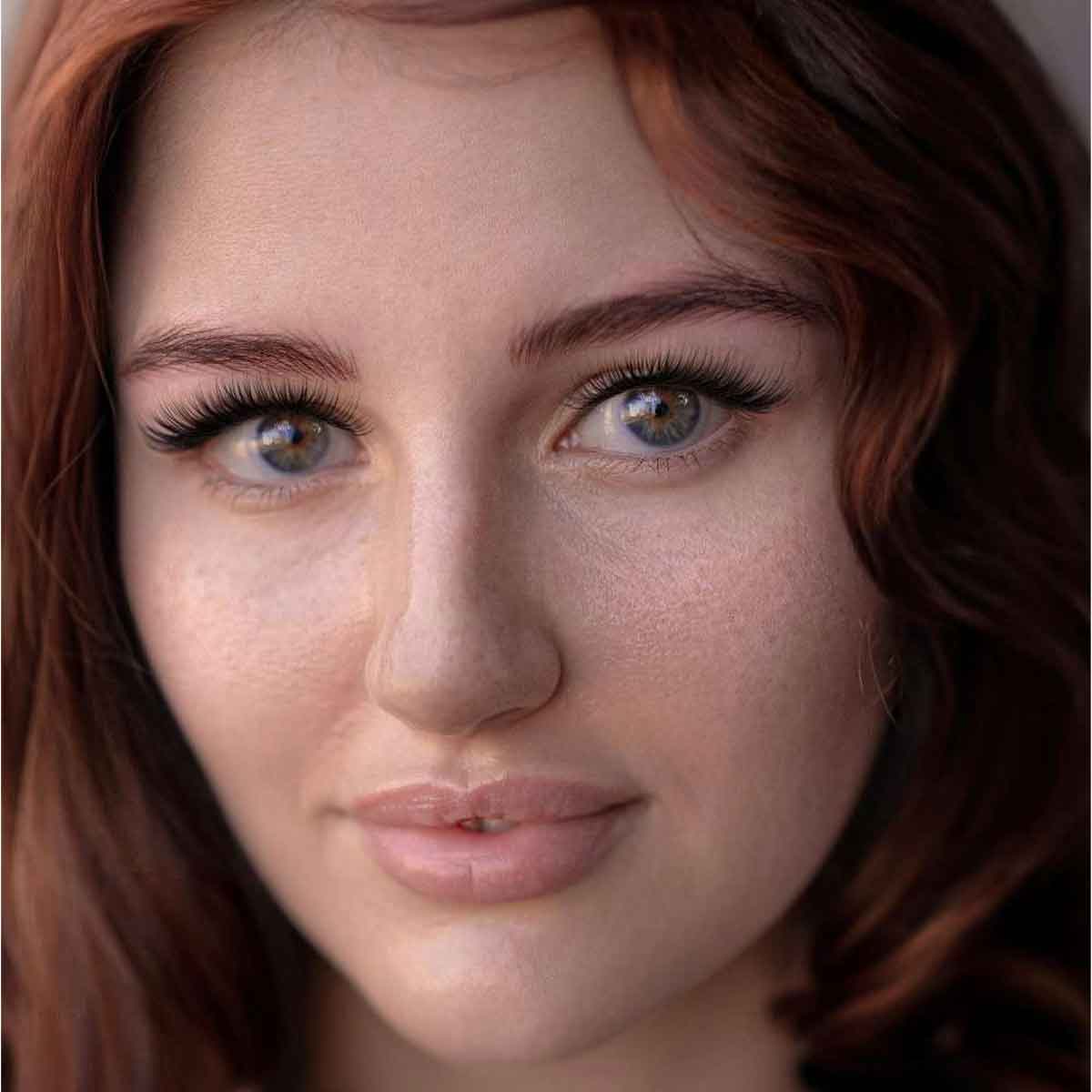 Close-up of a person with red hair and freckles