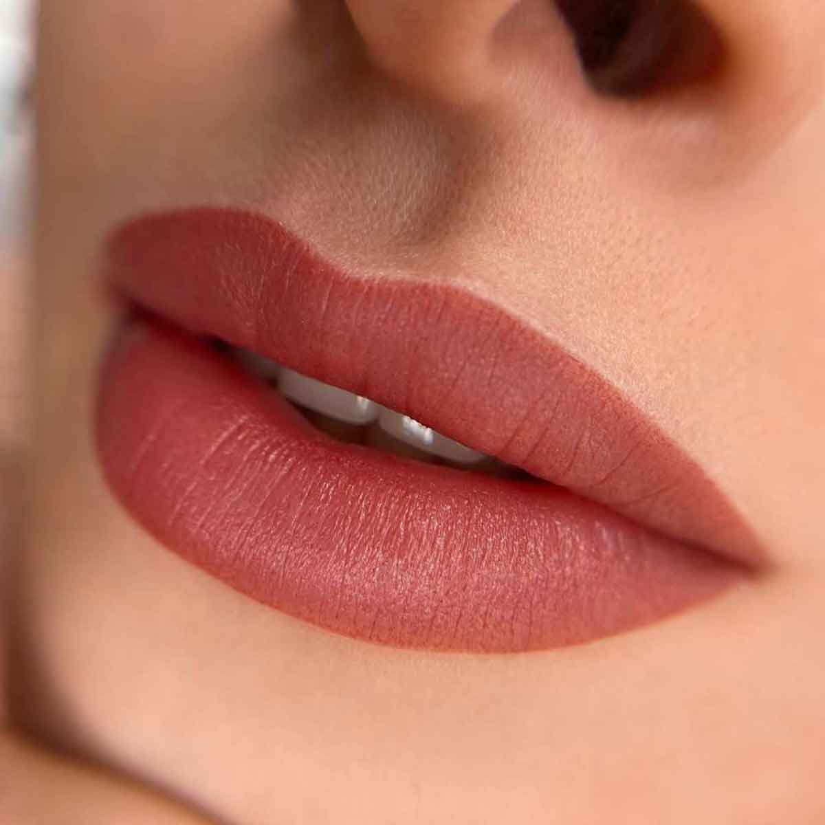 Close-up of a person's lips wearing a matte lipstick
