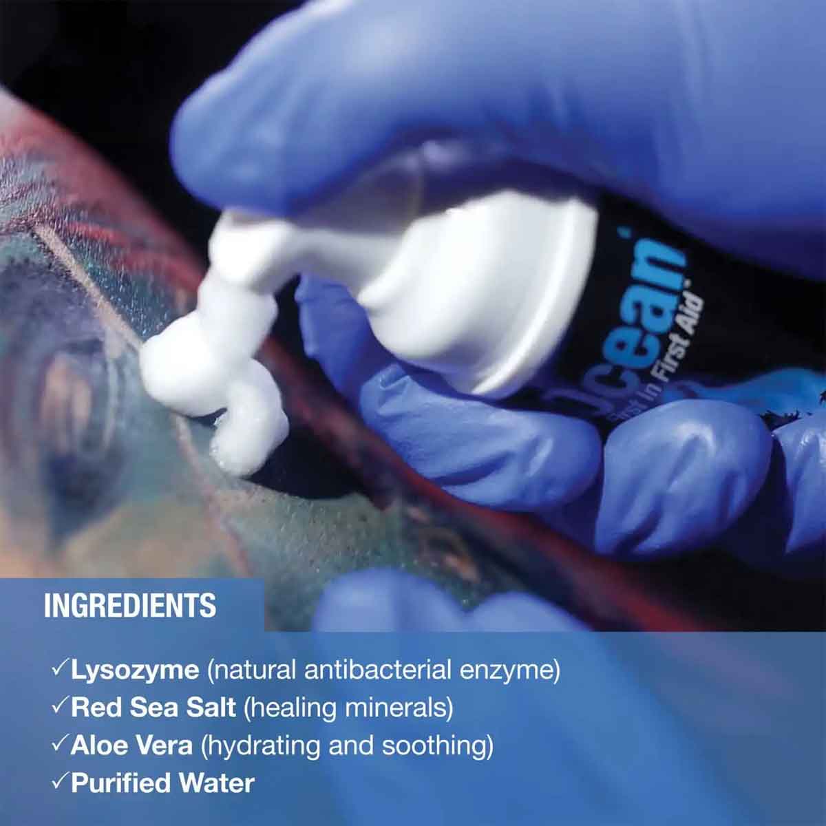 Person applying a white cream to a tattoo with a bottle labeled 'Red Sea' in the background.