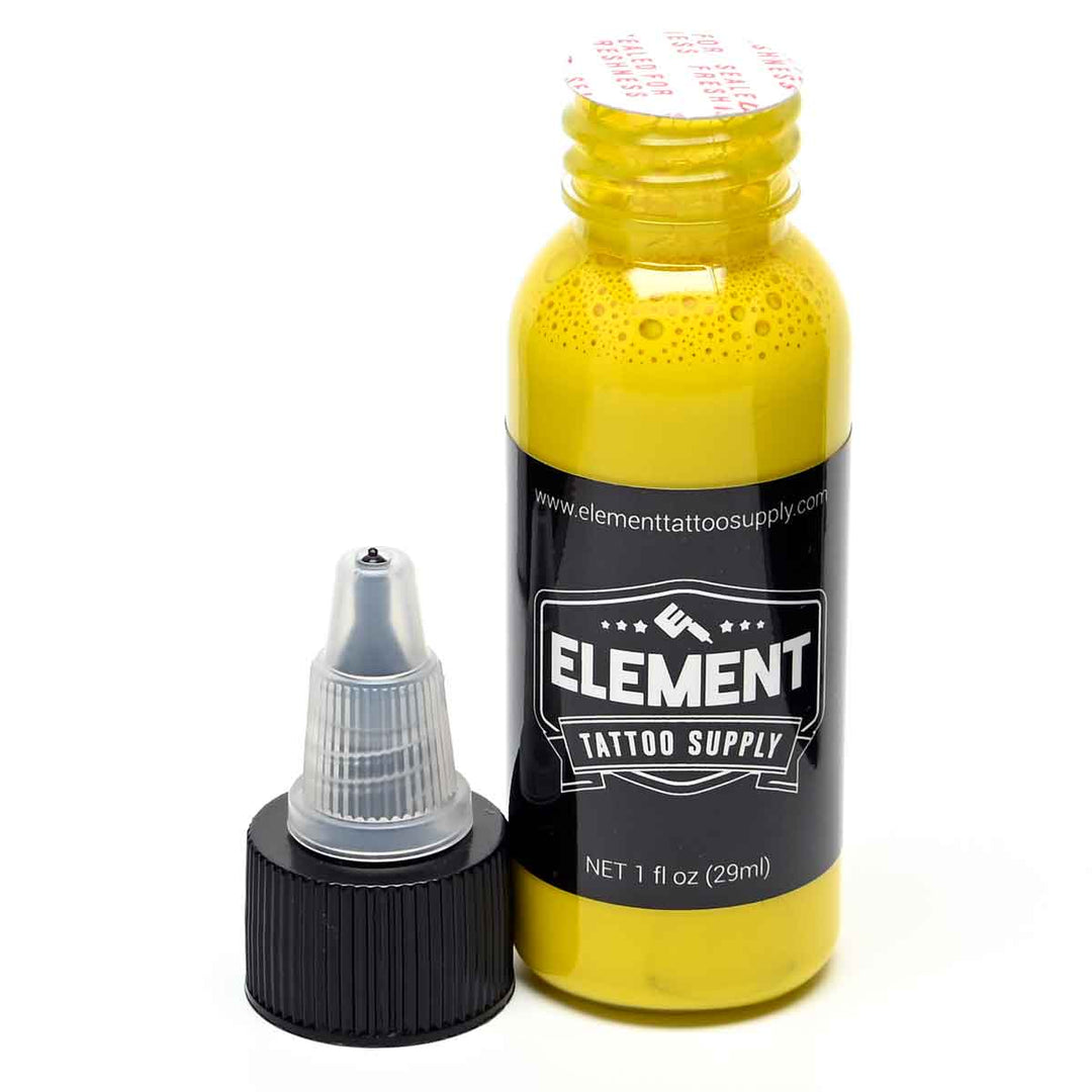 Open bottle with twist tap cap on the side of Element Tattoo Supply yellow TATTOO INK