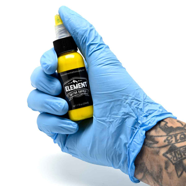 And with the blue glove holding yellow TATTOO INK by Element Tattoo Supply